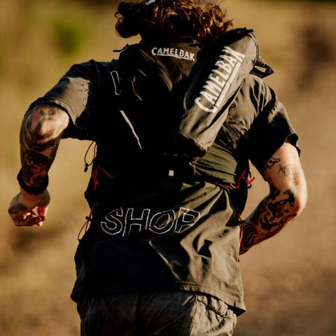 Man running wearing a camelback Hydration backpack