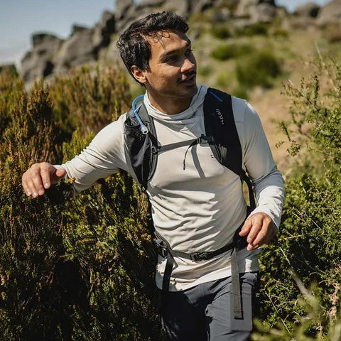 man hiking in a white outdoor shirt