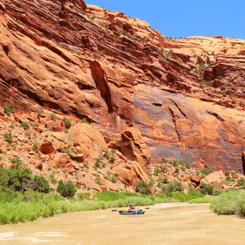 boat going down a red rock canyon