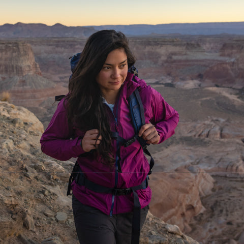 women wearing a purple jacket while hiking outside