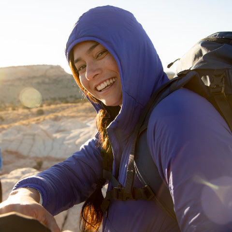 women wearing a purple jacket while hiking
