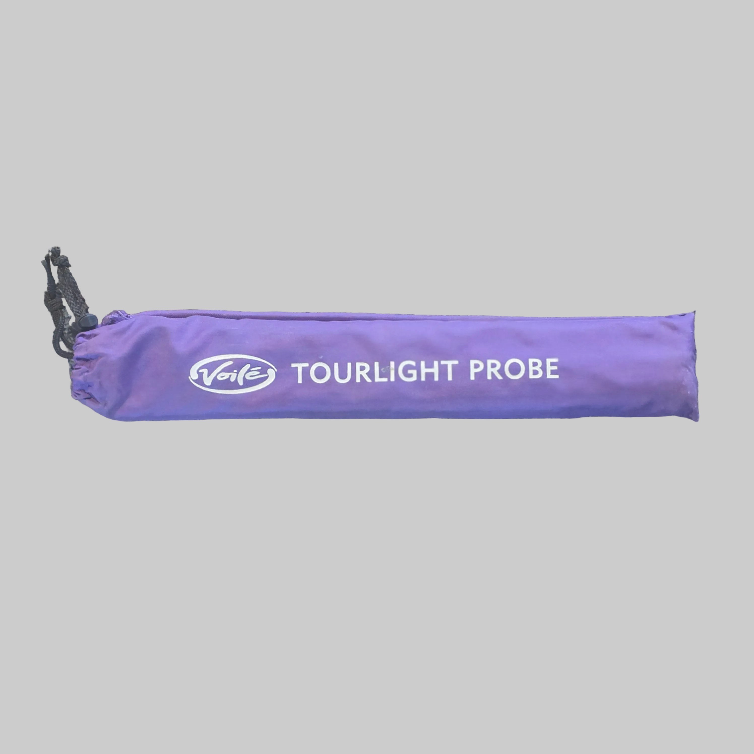 A purple drawstring carrying case for a 'Tourlight Probe' tool, laid flat on a speckled beige floor. The brand logo 'Takes' is visible in white on the front.
