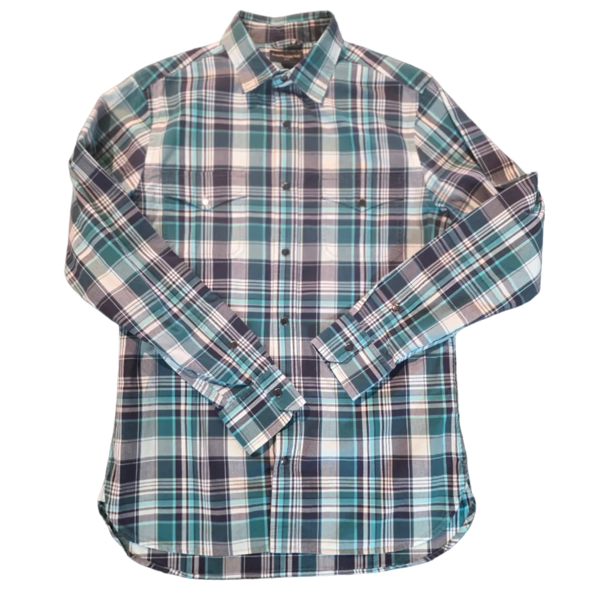 A long-sleeve plaid button-up shirt laid flat on a textured brown carpet. The shirt features a blue, green, white, and black plaid pattern.