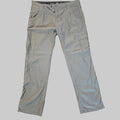 A pair of light gray cargo pants laid flat on a textured beige carpet.