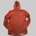 A rust-orange fleece zip-up hoodie with horizontal quilting, laid flat on a gray carpeted floor. The brand logo on the left chest reads 'The North Face'.