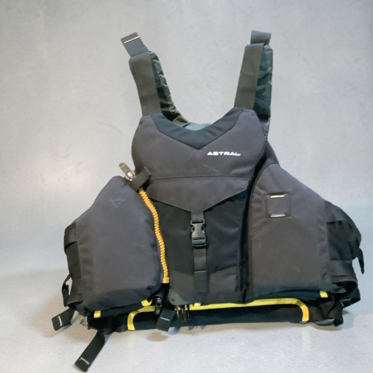High Desert Life Outdoors Astral charcoal grey PFD with yellow accents and adjustable straps for kayaking