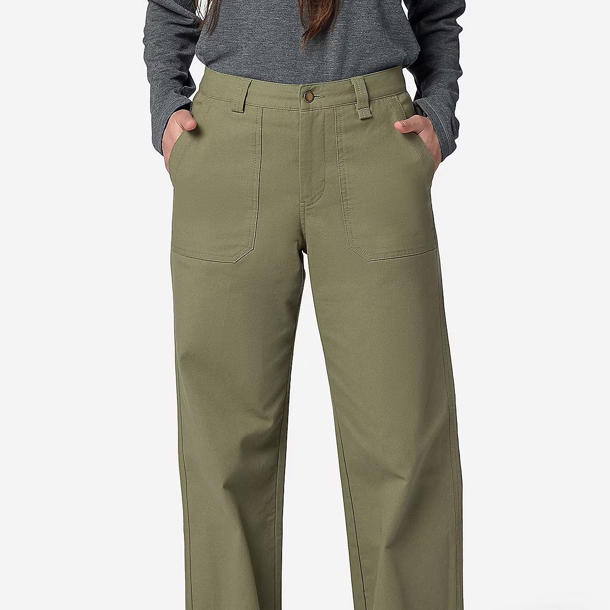 A person wearing olive green straight-leg work pants with a gray long-sleeve top and tan shoes, standing against a light gray studio background.