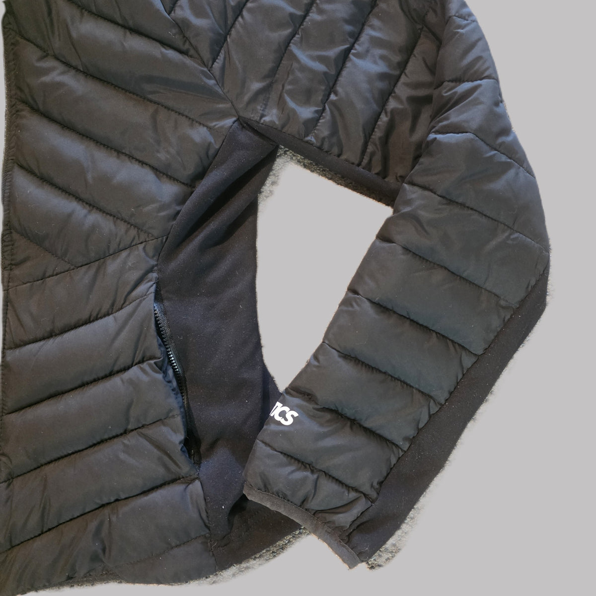 Fabletics jacket stretch side panels and zippered pocket detail